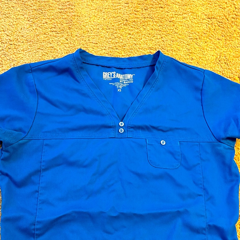 Greys Anatomy. Royal Blue scrub top. 2 pockets. Size XS